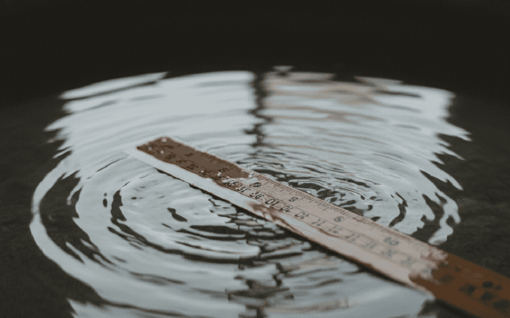 A ruler trying to measuring ripples in water