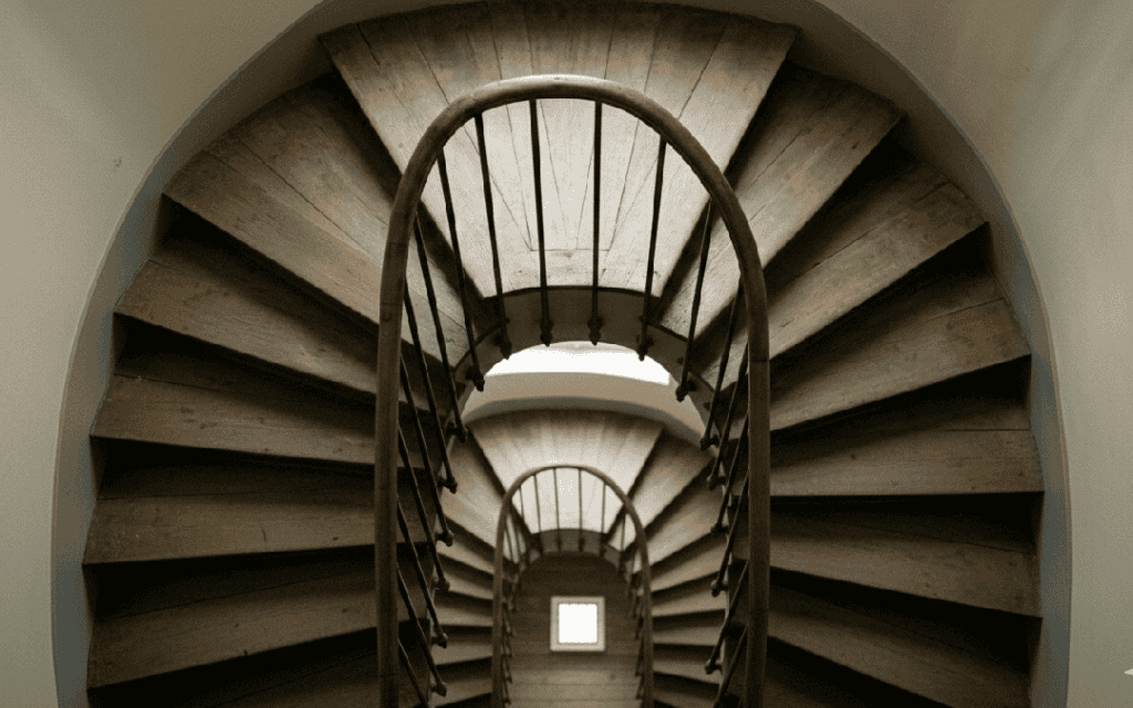 a downwards look at a long spiral staircase